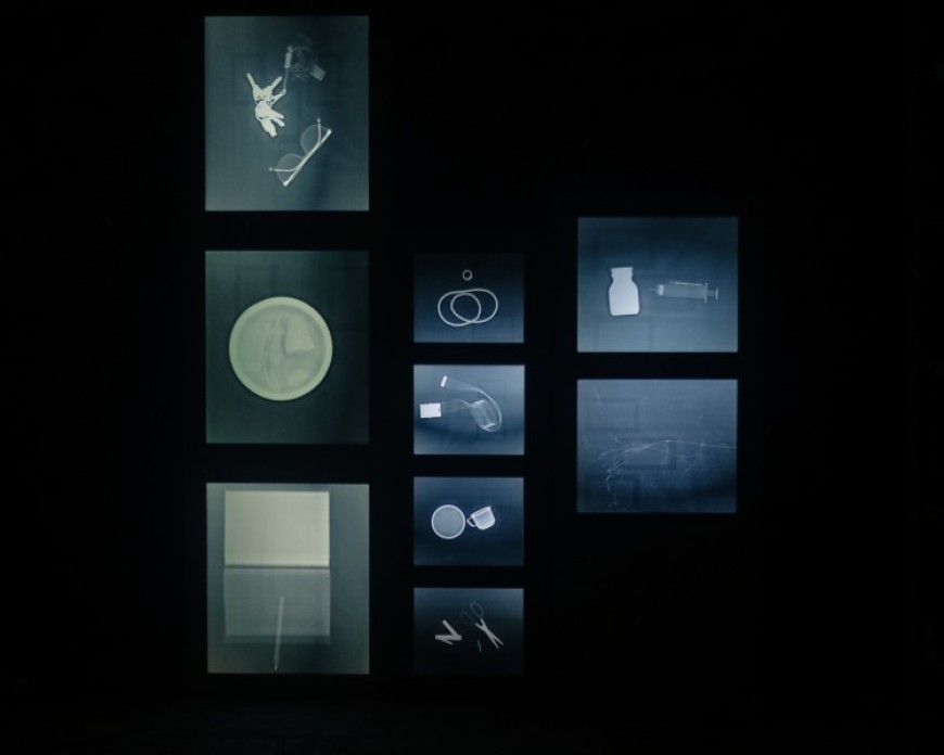 A collection of x-rays of various objects, like keys, glasses and a book.