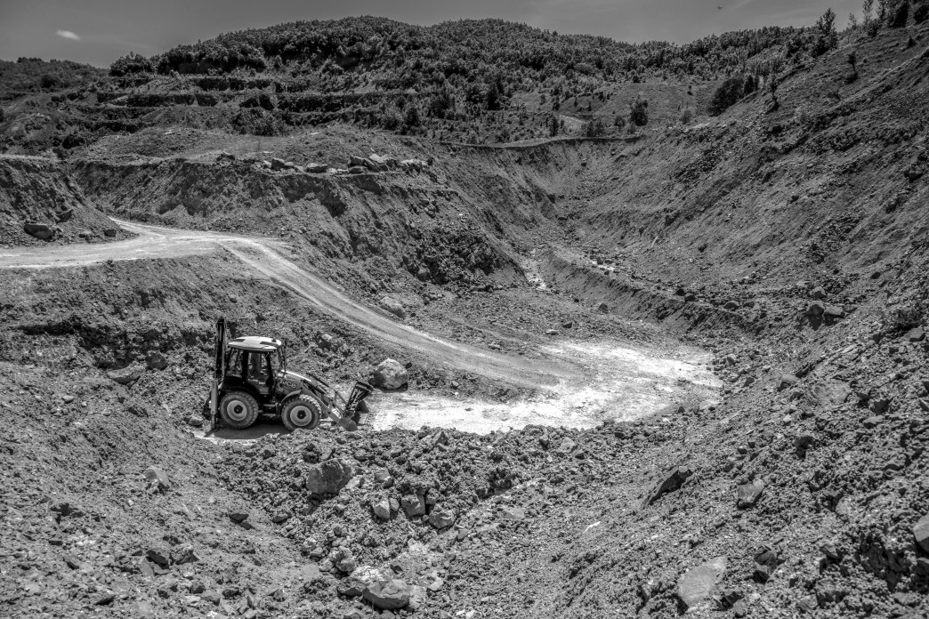 Un bulldozer creuse au fond d'un puits.
