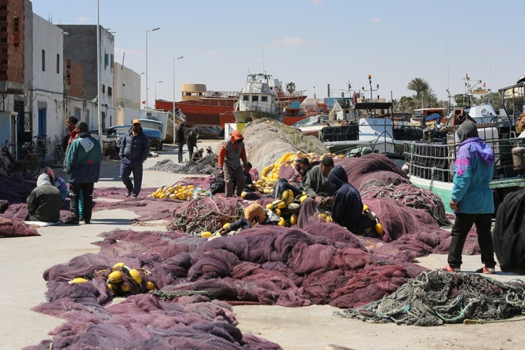 A group of fishermen in Gabes gather around their empty nets. They cannot catch fish in the polluted sea.