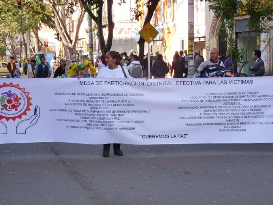 Protesters holding a large banner at a protest.