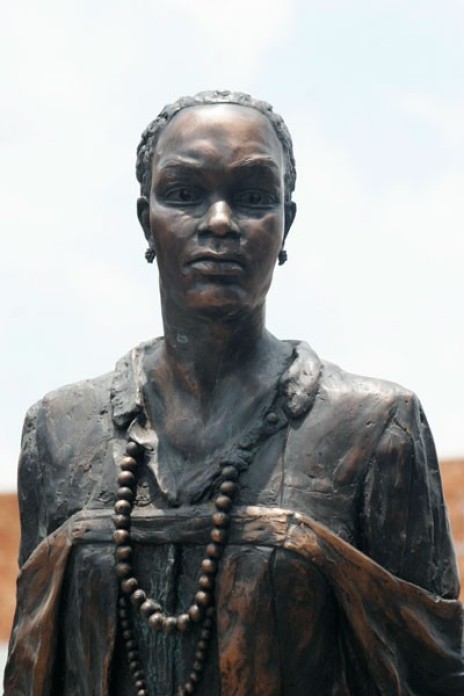 A bronze statue of a woman.