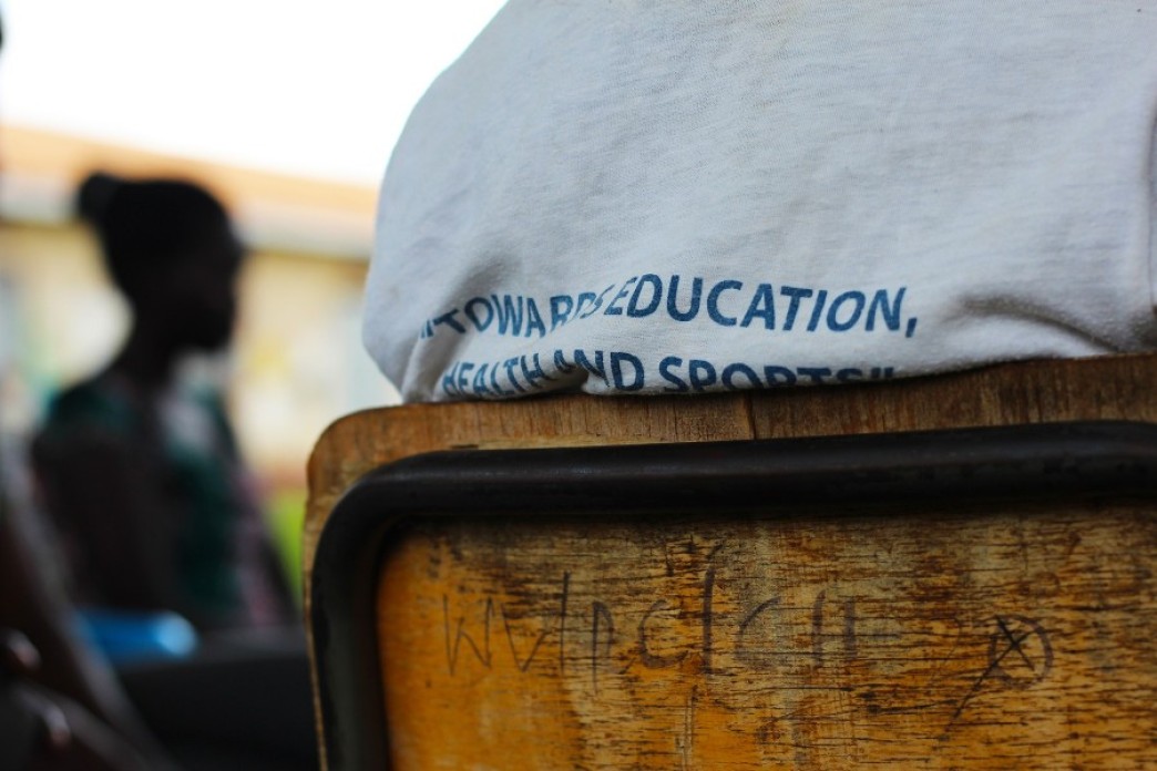 A person sitting in a chair watching a presentation.
