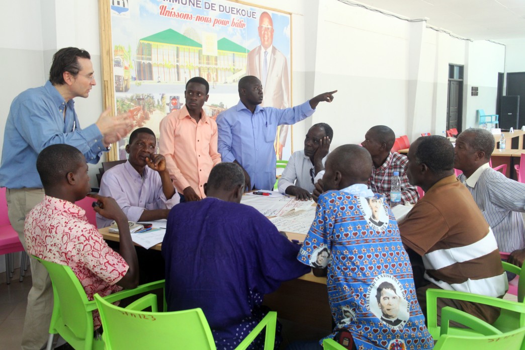 People gathered around a table talking.