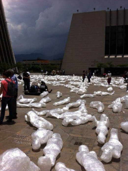 Plastic bodies spread throughout a central square.