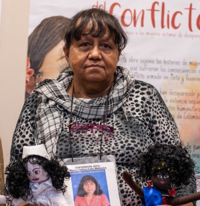 A woman with a photograph in her hands.